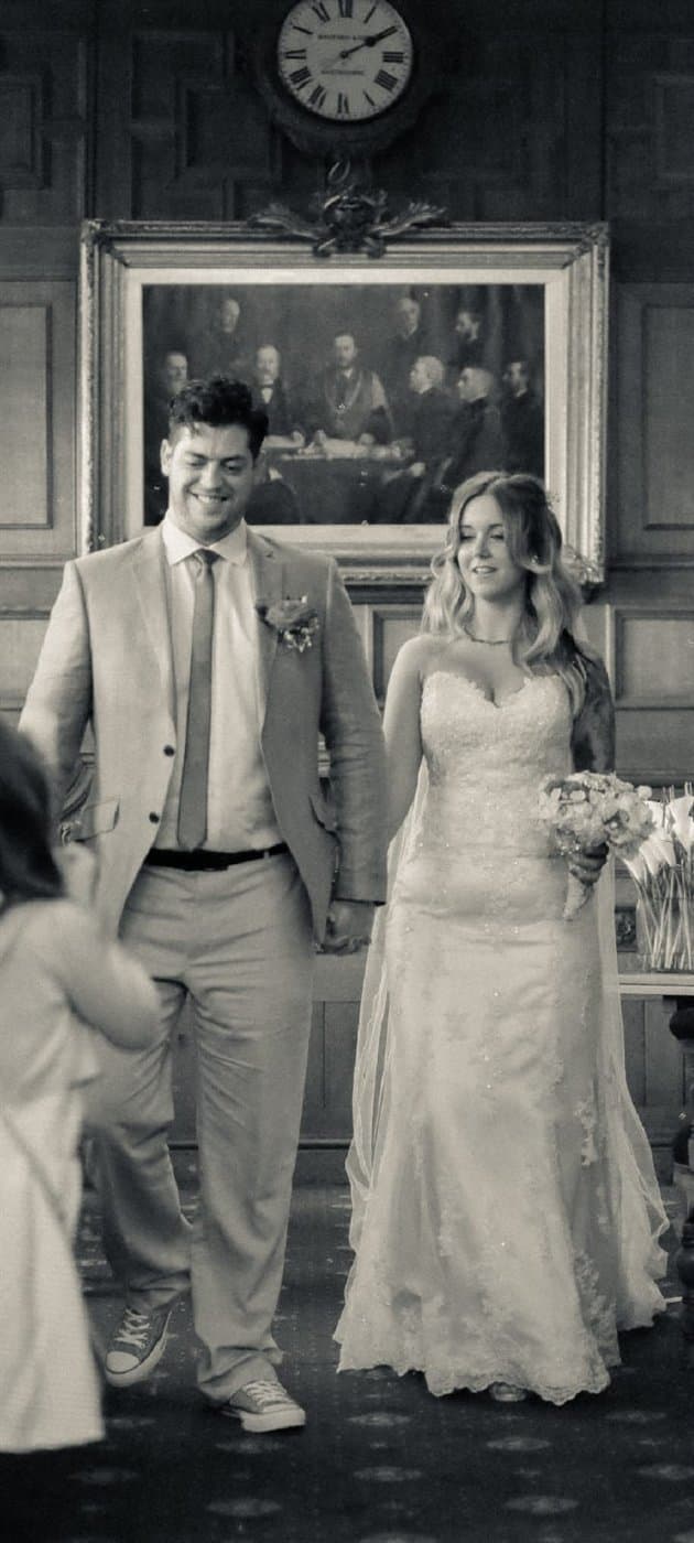 A couple walking back down the aisle, hand in hand, just married